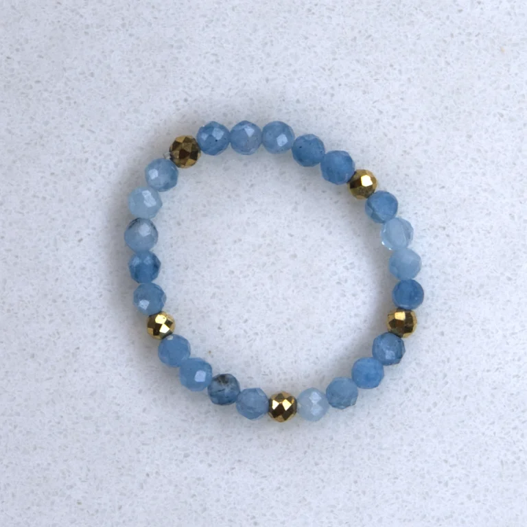 Gemstone aquamarine ring on spotted white marble background