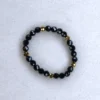 Gemstone black spinel ring on spotted white marble background