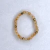 Gemstone citrine ring on spotted white marble background