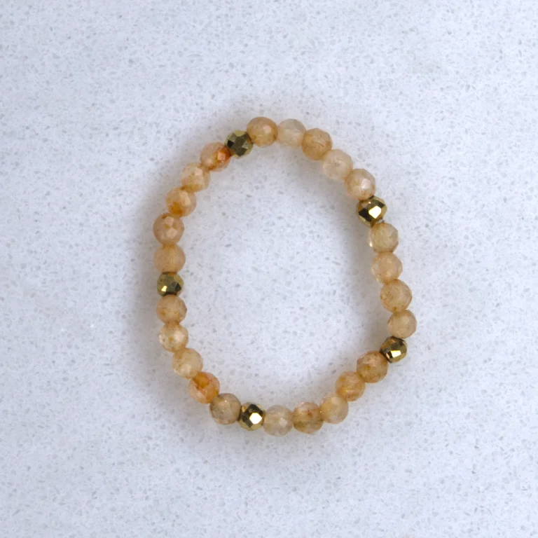 Gemstone citrine ring on spotted white marble background