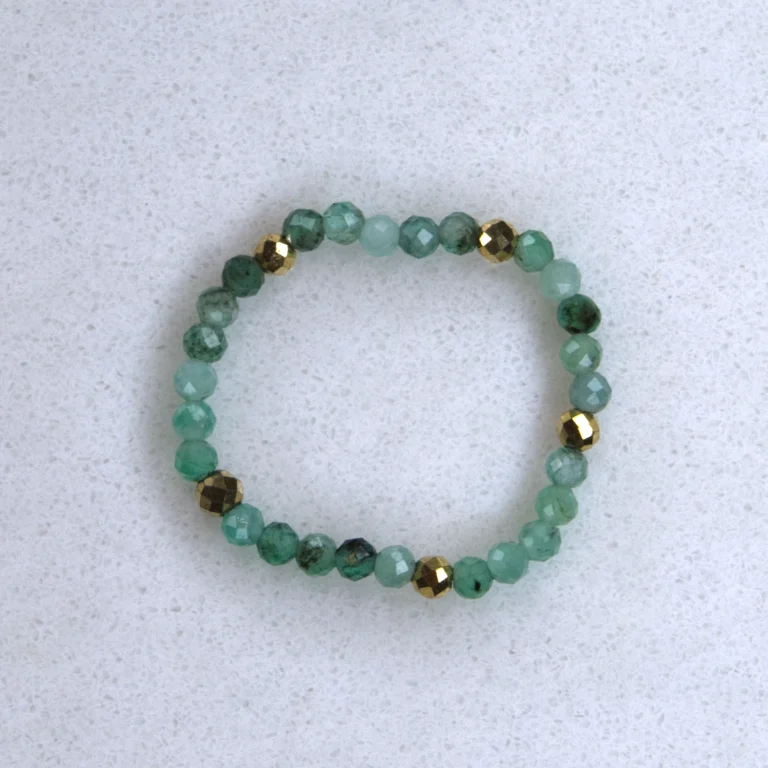 Gemstone emerald ring on spotted marble background