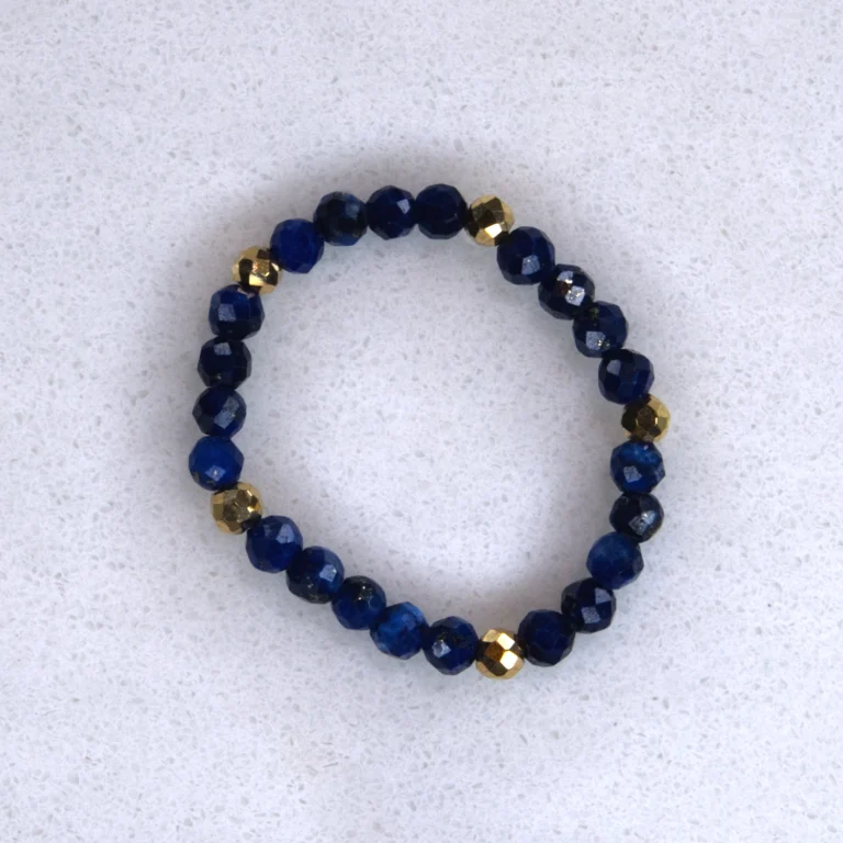 Gemstone lapis ring on spotted white marble background