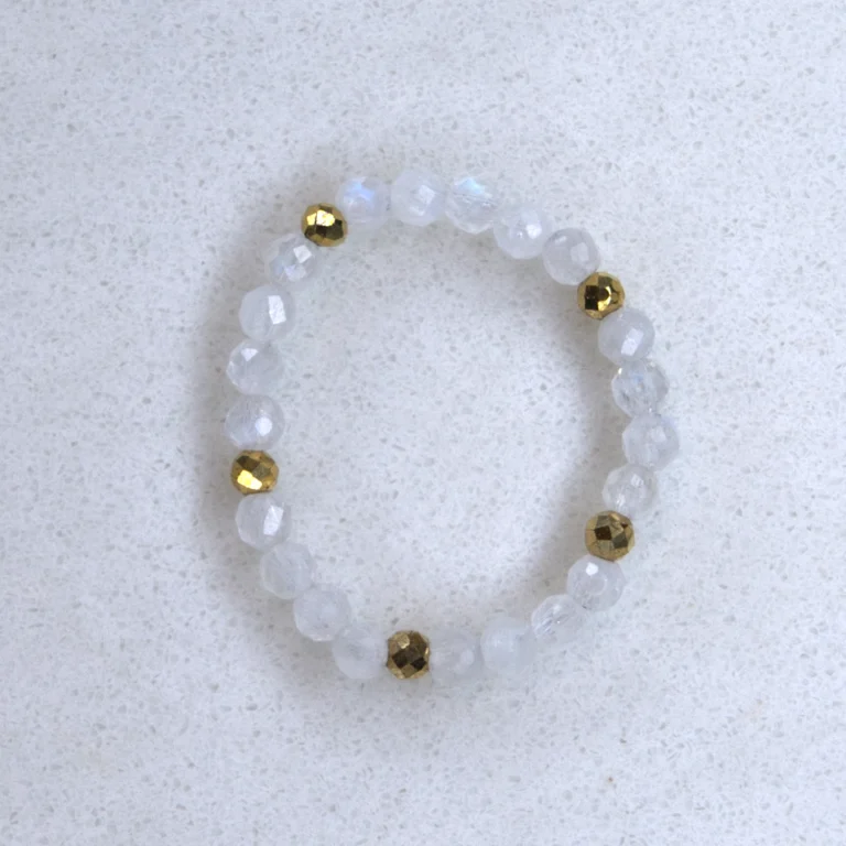 Gemstone moonstone ring on spotted white marble background