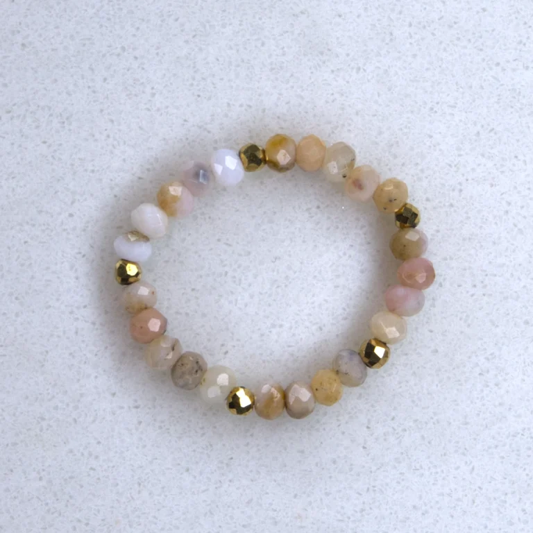 Gemstone rhodochrosite ring on spotted white marble background