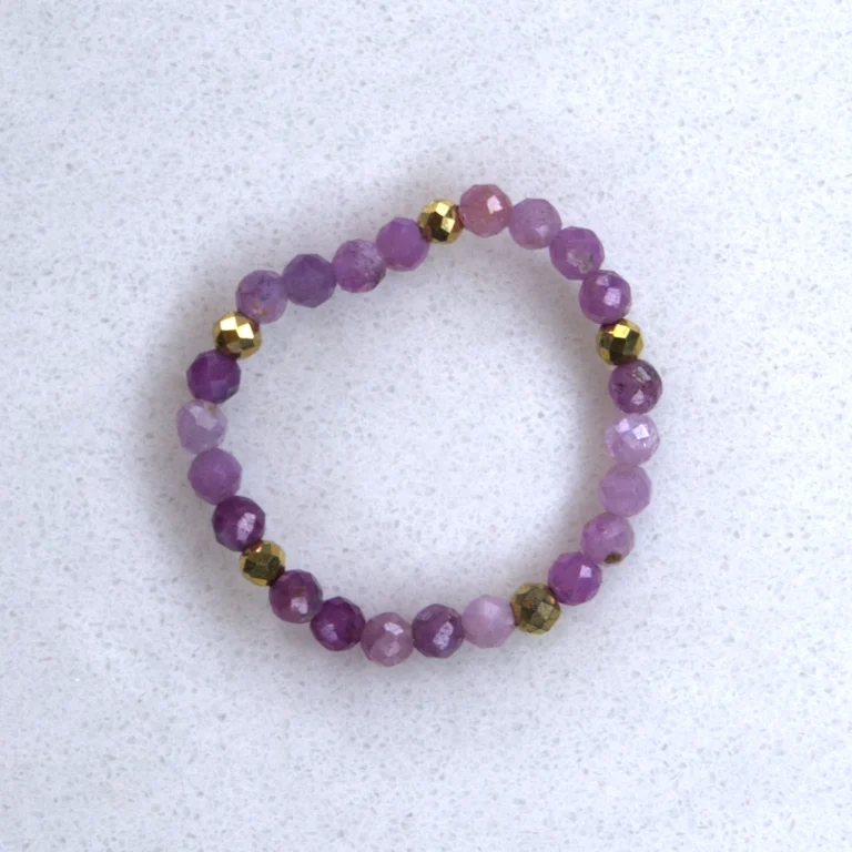 Gemstone ruby ring on spotted white marble background