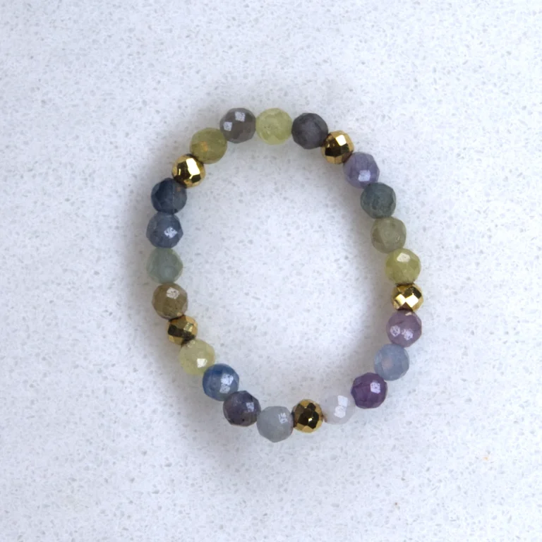 Gemstone sapphire ring on spotted white marble background