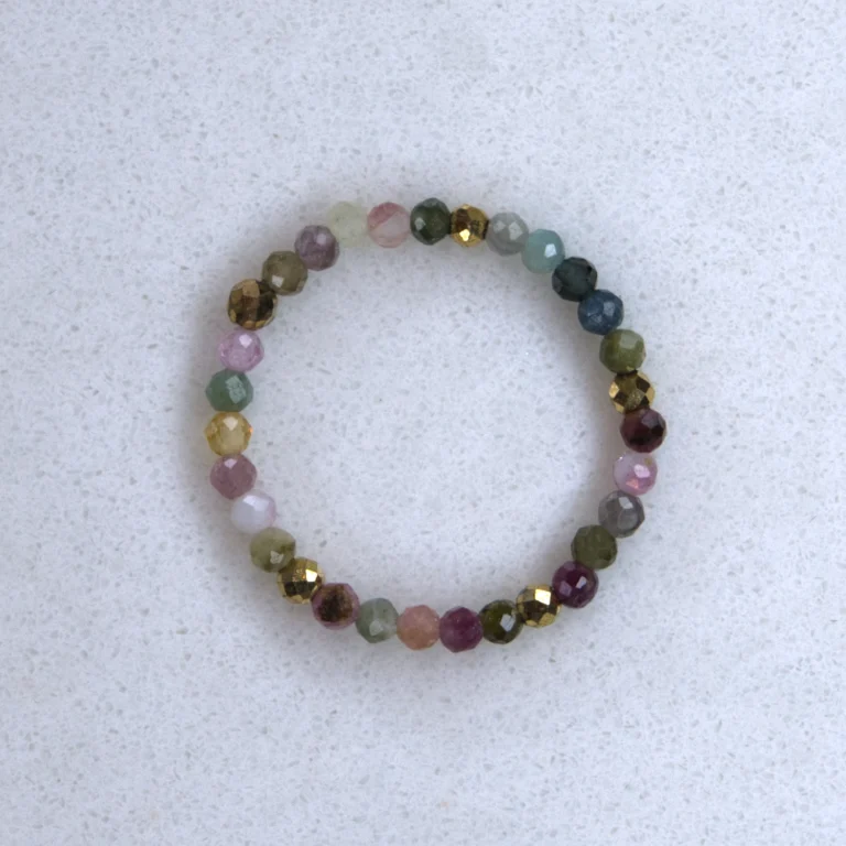 Gemstone tourmaline ring on spotted white marble background