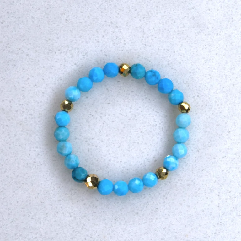 Gemstone turquoise ring on spotted white marble background