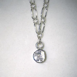 sterling silver courage necklace with sterling silver polki diamond pendant on white speckled background