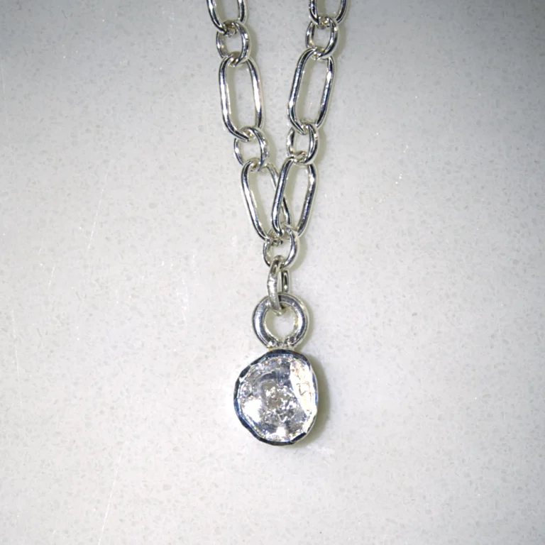 sterling silver courage necklace with sterling silver polki diamond pendant on white speckled background