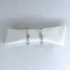sterling silver chain link hoop earrings with white speckled background