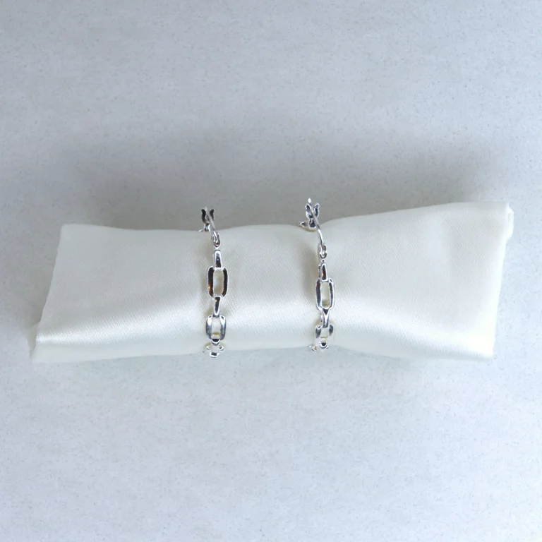 sterling silver chain link hoop earrings with white speckled background