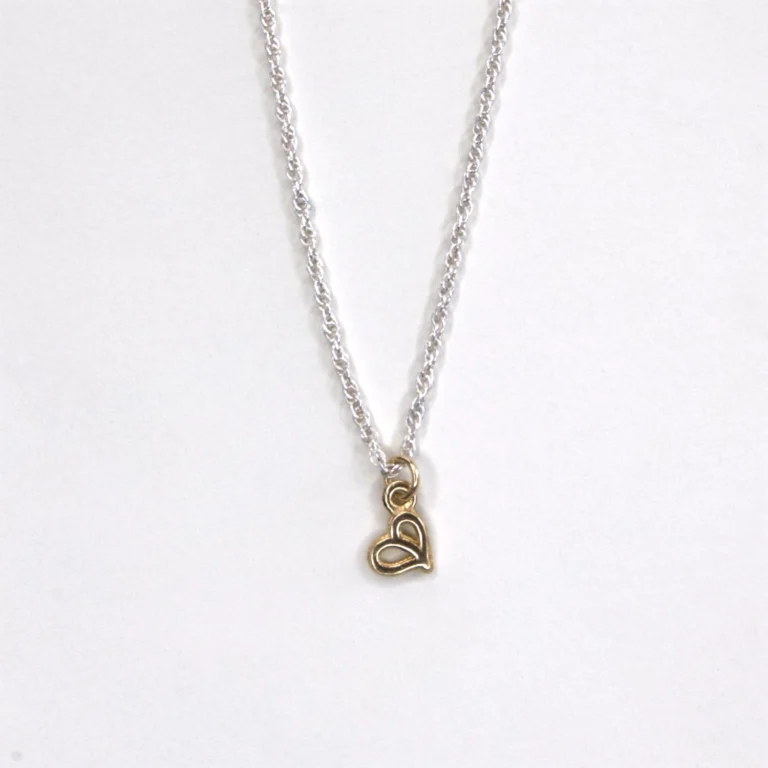 partial view sterling silver rope chain with a 14K yellow gold authentic pendant on white background