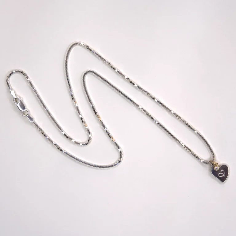 full view sterling silver Venetian necklace with a sterling silver authentic heart pendant and a 14K yellow gold diamond pendant on white background