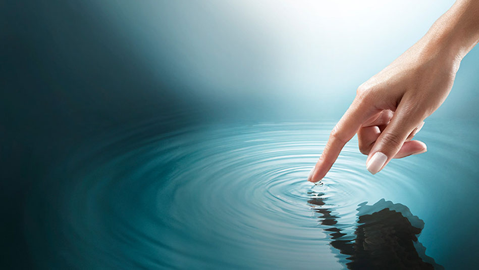 finger touching water with ripples