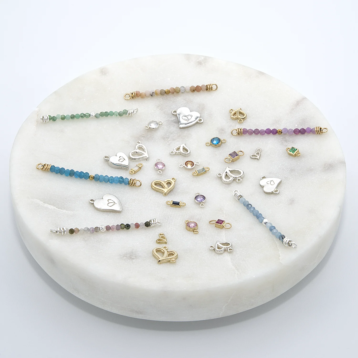 Assorted gold and silver jewelry connectors, charms and pendants